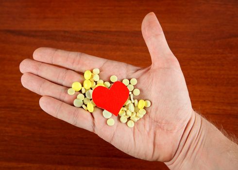 Heart Shape with the Pills in the Hand closeup