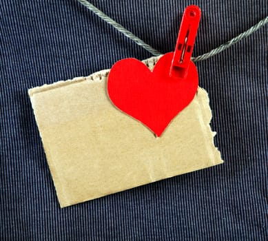 Red Heart Shape and Paper on the Rope and the Textile Background