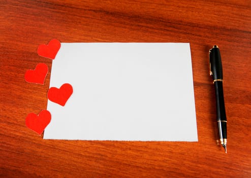 Blank Writing Pad with Heart Shapes and Pen on The Table