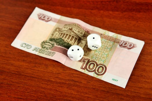 Hundred Russian Roubles and Dices on the Wooden Background