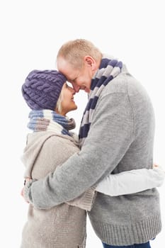 Happy mature couple in winter clothes hugging on white background