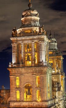 Metropolitan Cathedral Steeples Bells Statues in Zocalo, Center of Mexico City, at Night