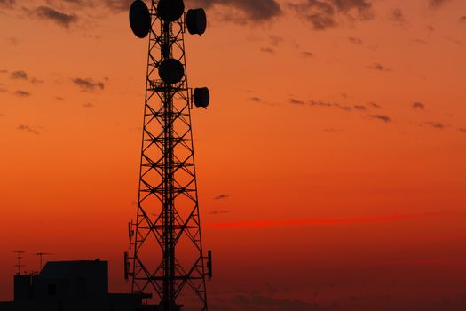 Telecommunication tower structure with sunset sky background