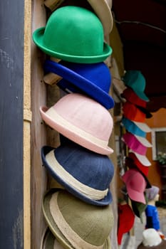 Colorful summer hats lie on the counter