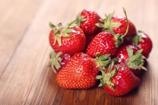 heap red ripe,fresh strawberry on a wooden background