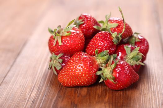 heap red ripe,fresh strawberry on a wooden background