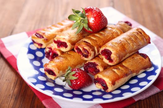 cakes with fresh strawberry on blue plate