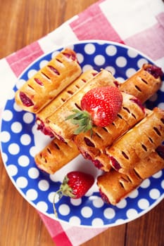 cakes with fresh strawberry on blue plate