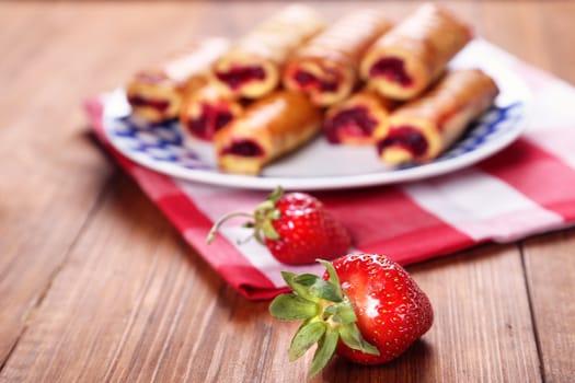 cakes with fresh strawberry on blue plate