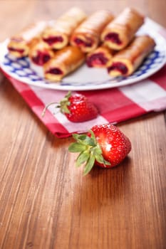 cakes with fresh strawberry on blue plate