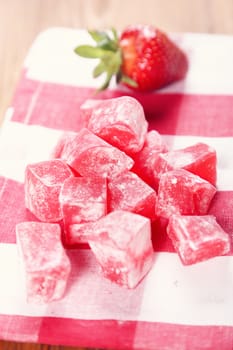Turkish delight of red pieces,with strawberry on textile