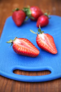 some red ripe,fresh strawberry on blue plate