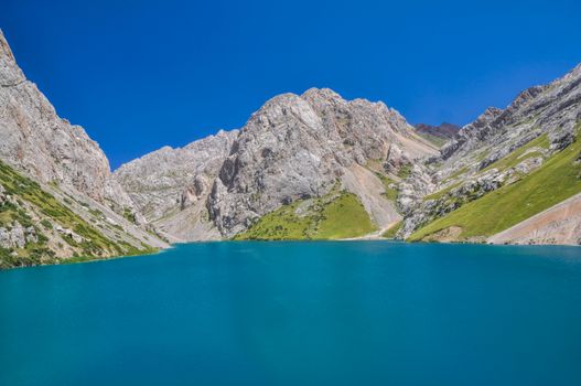 Scenic turquoise lake in mountain range Tien-Shan in Kyrgyzstan