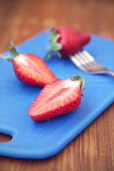 some red ripe,fresh strawberry on blue plate