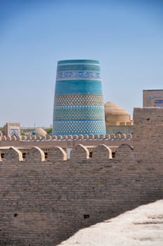 Blue decorated minaret in Khiva, historical town in Uzbekistan