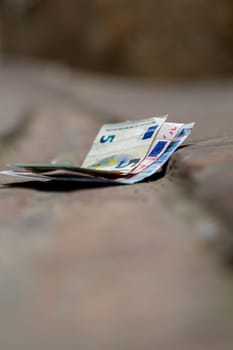 euro bill lost in the pedestrian walkway