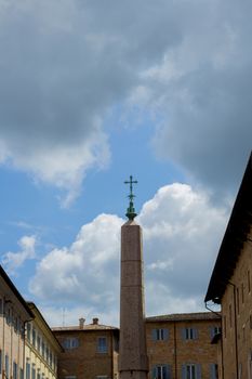 cross in the middle of square in the old city