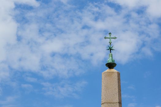 Obelisk whit cross in the square