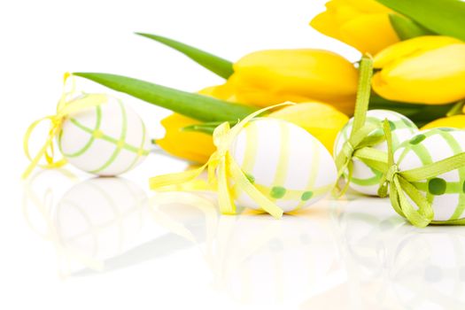 easter eggs with yellow tulip flowers isolated on white background