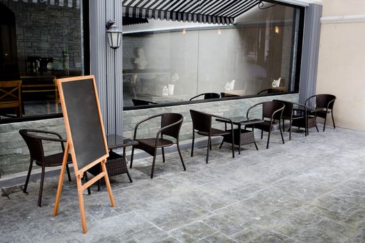 Concept and design front of Coffee Shop with black board and black seating