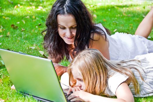 Photo of learning mother and daughter in summer