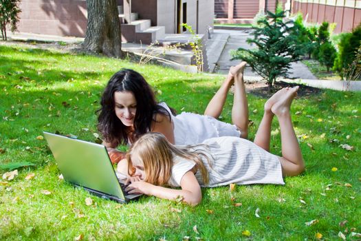 Photo of learning mother and daughter in summer