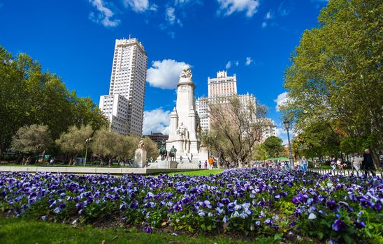 Madrid, Spain - May 6, 2012: Spain Square with monument to Cervantes, Torre de Madrid and Edificio Espana in Madrid on a sunny spring day, Spain
