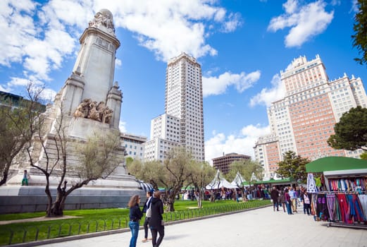Madrid, Spain - May 6, 2012: Spain Square with monument to Cervantes, Torre de Madrid and Edificio Espana in Madrid on a sunny spring day, Spain