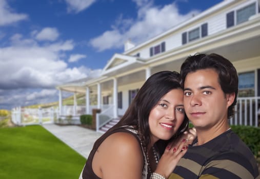 Young Happy Hispanic Young Couple in Front of Their New Home.