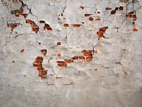background or texture cracks in plaster on brick wall