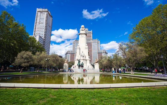 Madrid, Spain - May 6, 2012: Spain Square with monument to Cervantes, Torre de Madrid and Edificio Espana in Madrid on a sunny spring day, Spain