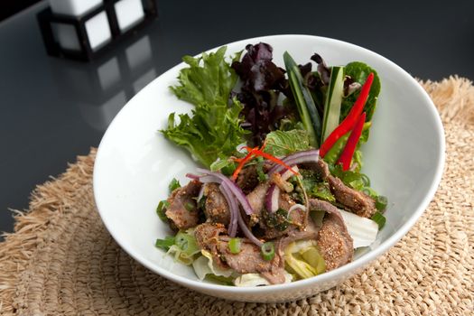 Asian style Thai salad with steak and fresh vegetables.