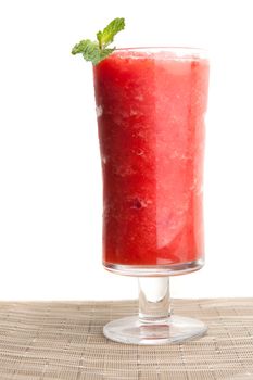 Red fruit flavored frozen cocktail or smoothie beverage with straw and stirring stick.