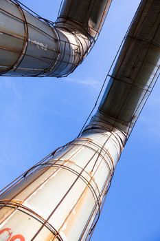 Elevated section of the pipelines against the blue sky