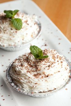 Parfait desserts with fresh whipped cream and chocolate shavings. Shallow depth of field.