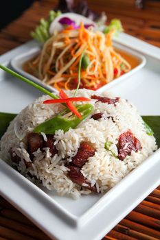 Traditional dish of freshly prepared Thai food with som tum green papaya salad.