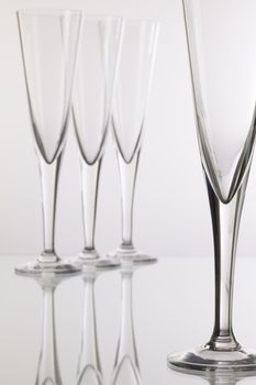 Empty champagne glasses on the glass desk