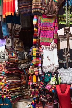LA PAZ, BOLIVIA - NOVEMBER 10, 2014: Colorful sweaters, bags and scarves haging outside a handicraft and souvenir shop on Linares street in the city center on November 10, 2014 in La Paz, Bolivia. 