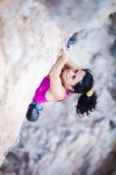 Young female rock climber on a cliff face