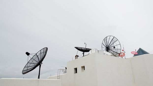 Many satellite dishes on the roof