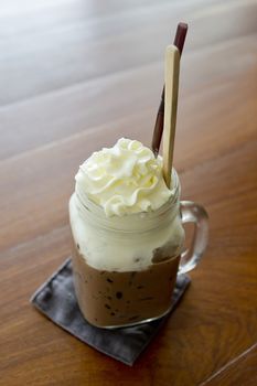 Ice chocolate with whipped cream on table