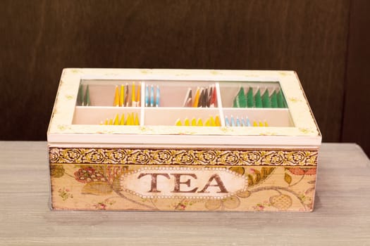 Many tea bags in a container , hand painted