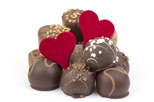 delicious chocolate and hearts on white background