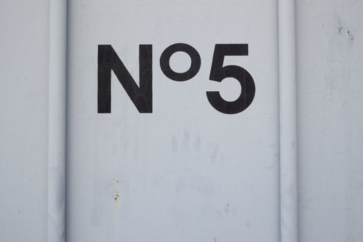 number 5 wroten in black on a white container door