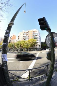 street in movement through a fisheye lens. Car and traffic light