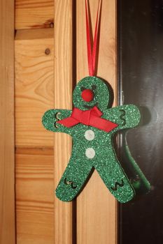 Green Christmas toy man in a wooden house