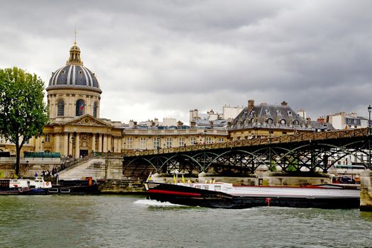 Photo shows various Parisian (France) houses, river and boats.