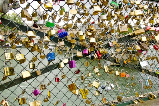 Photo shows various Parisian love locks on the bridge.