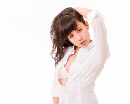 Chinese woman with unbuttoned shirt holding hair