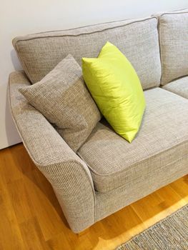 Detail of a living room with gray sofa and cushions.